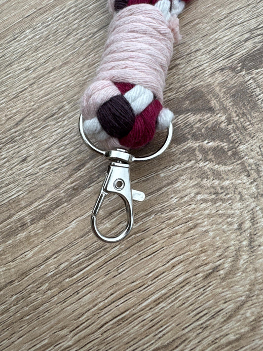 Keychain with colorful yarn-wrapped handle on a wooden surface