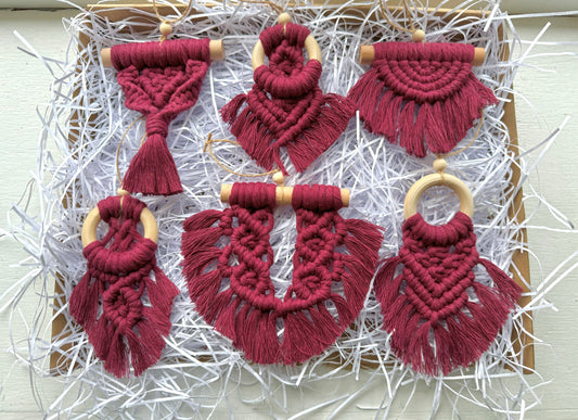Set of red macrame ornaments on a white background