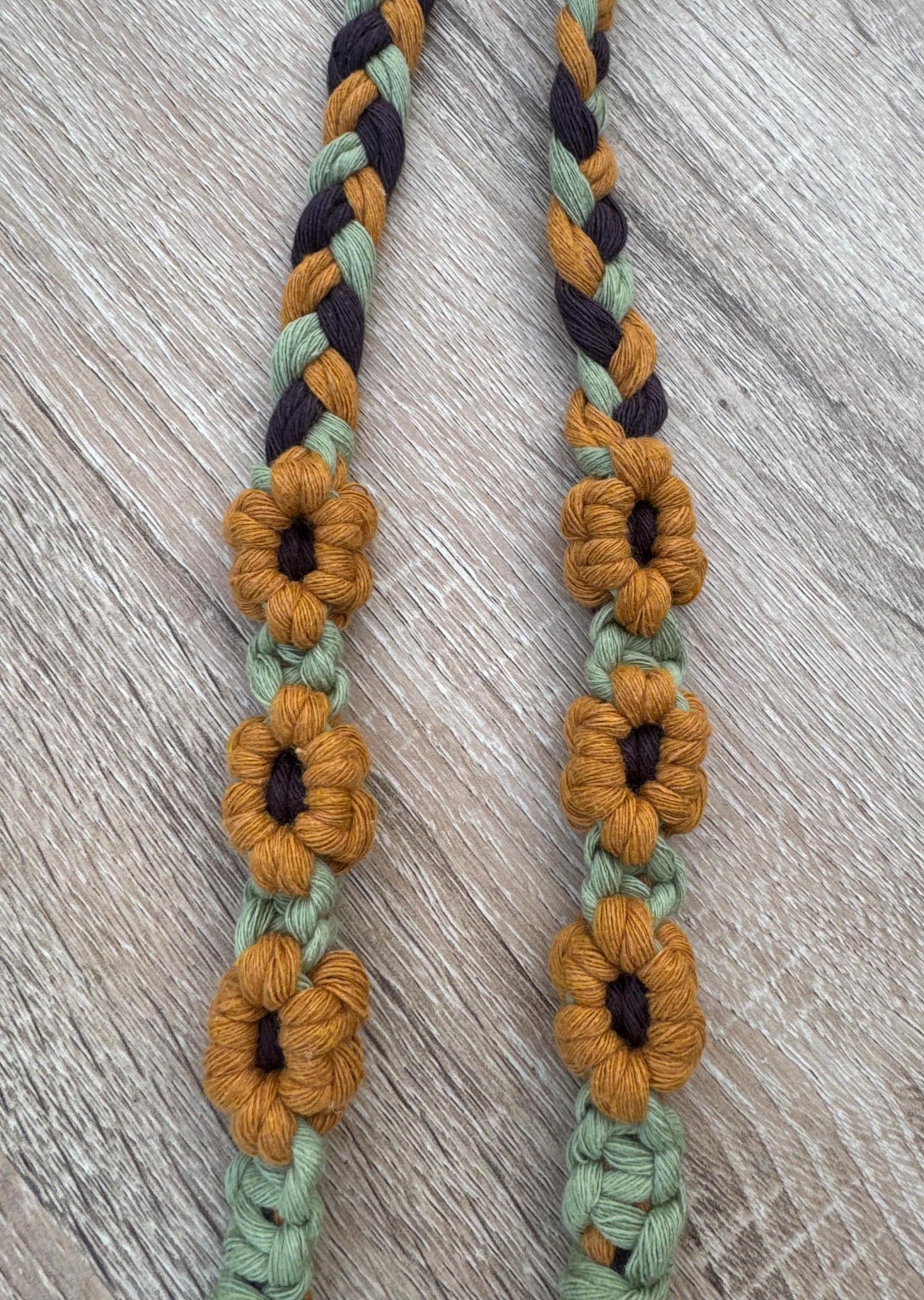 Braided macrame with sunflower designs on a wooden surface