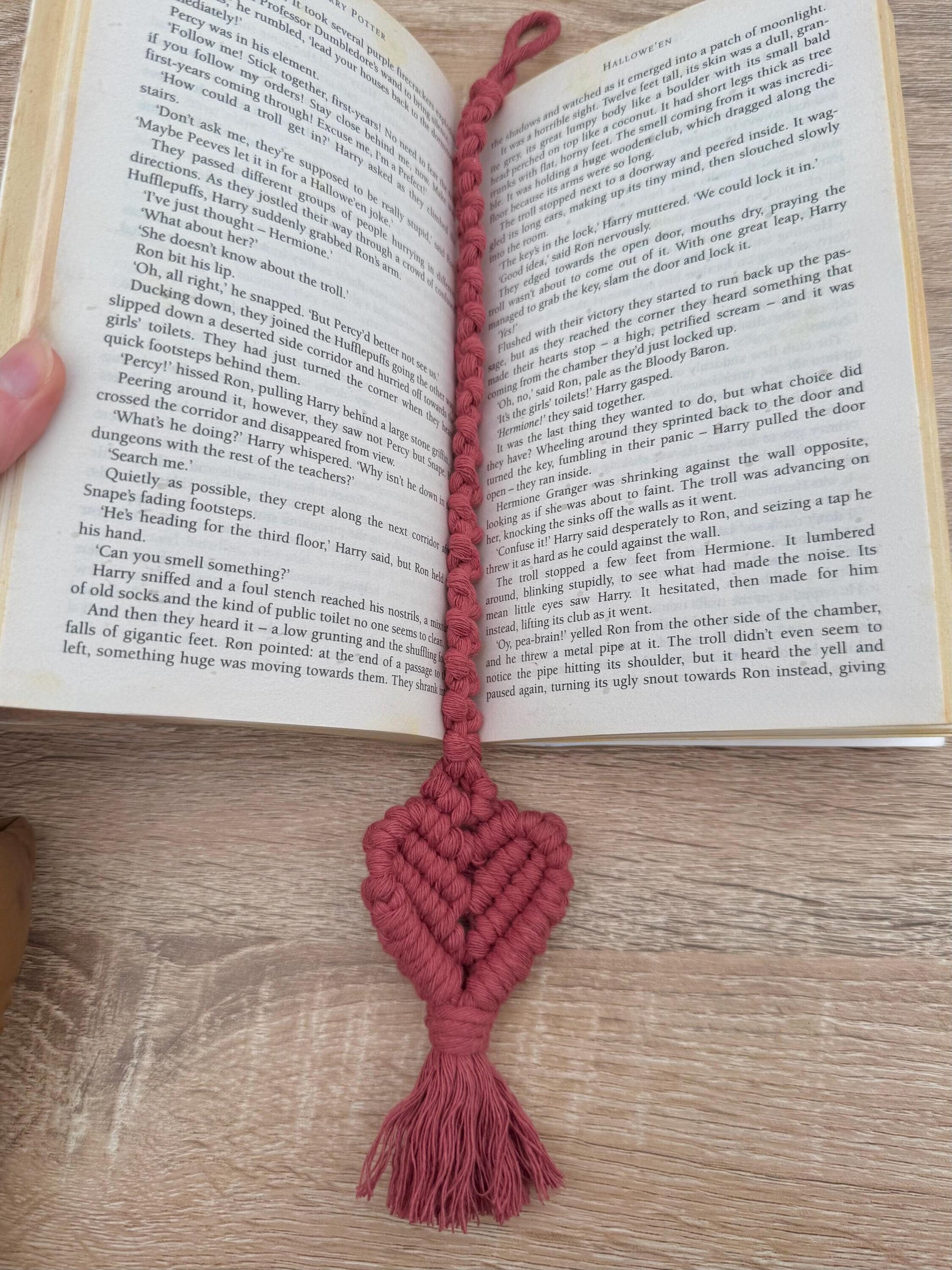 Macrame heart bookmark on an open book