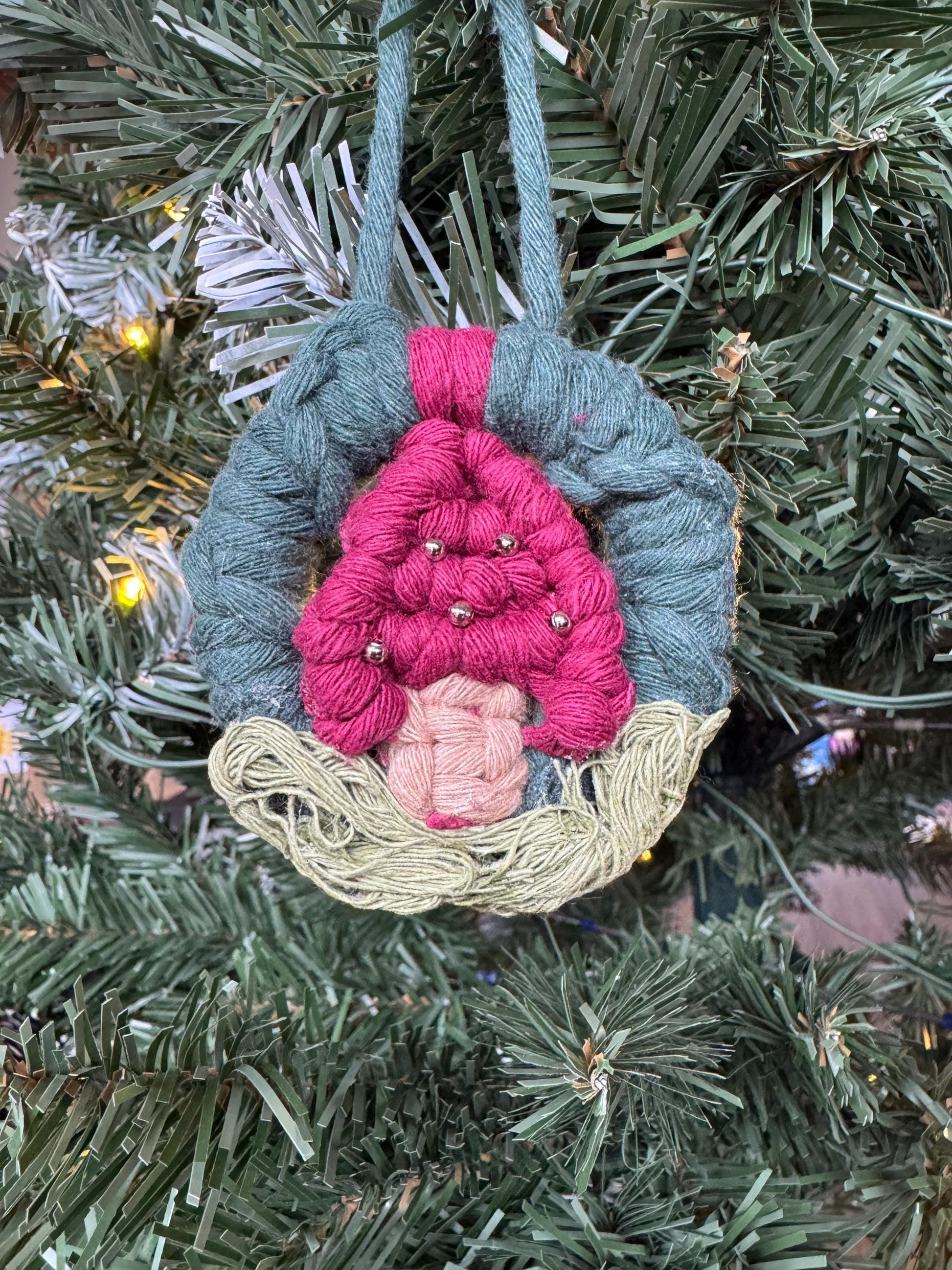 Decorative mushroom ornament hanging on a Christmas tree.