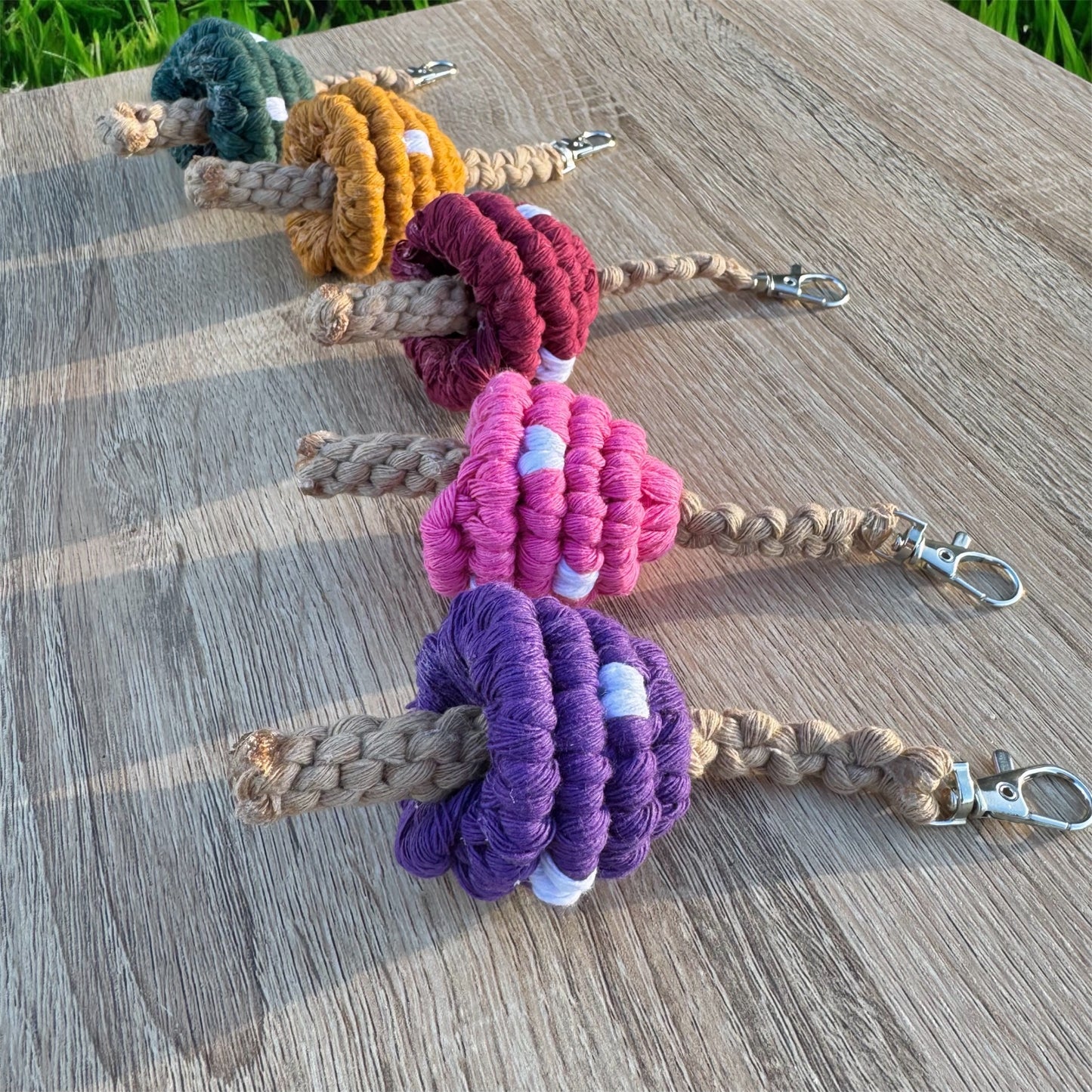 Set of colorful mushroom macrame keychains on a wooden surface