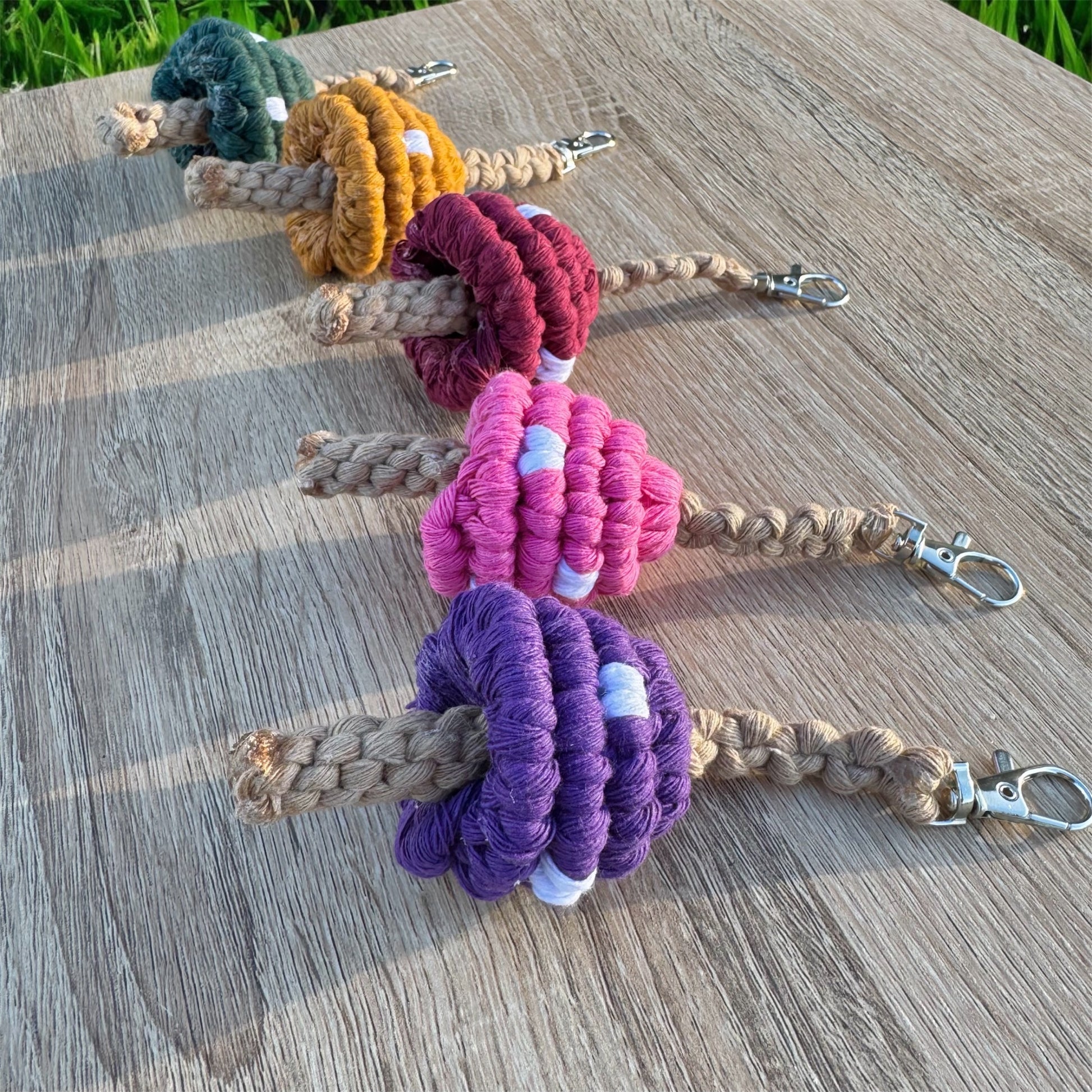 Set of colorful mushroom macrame keychains on a wooden surface