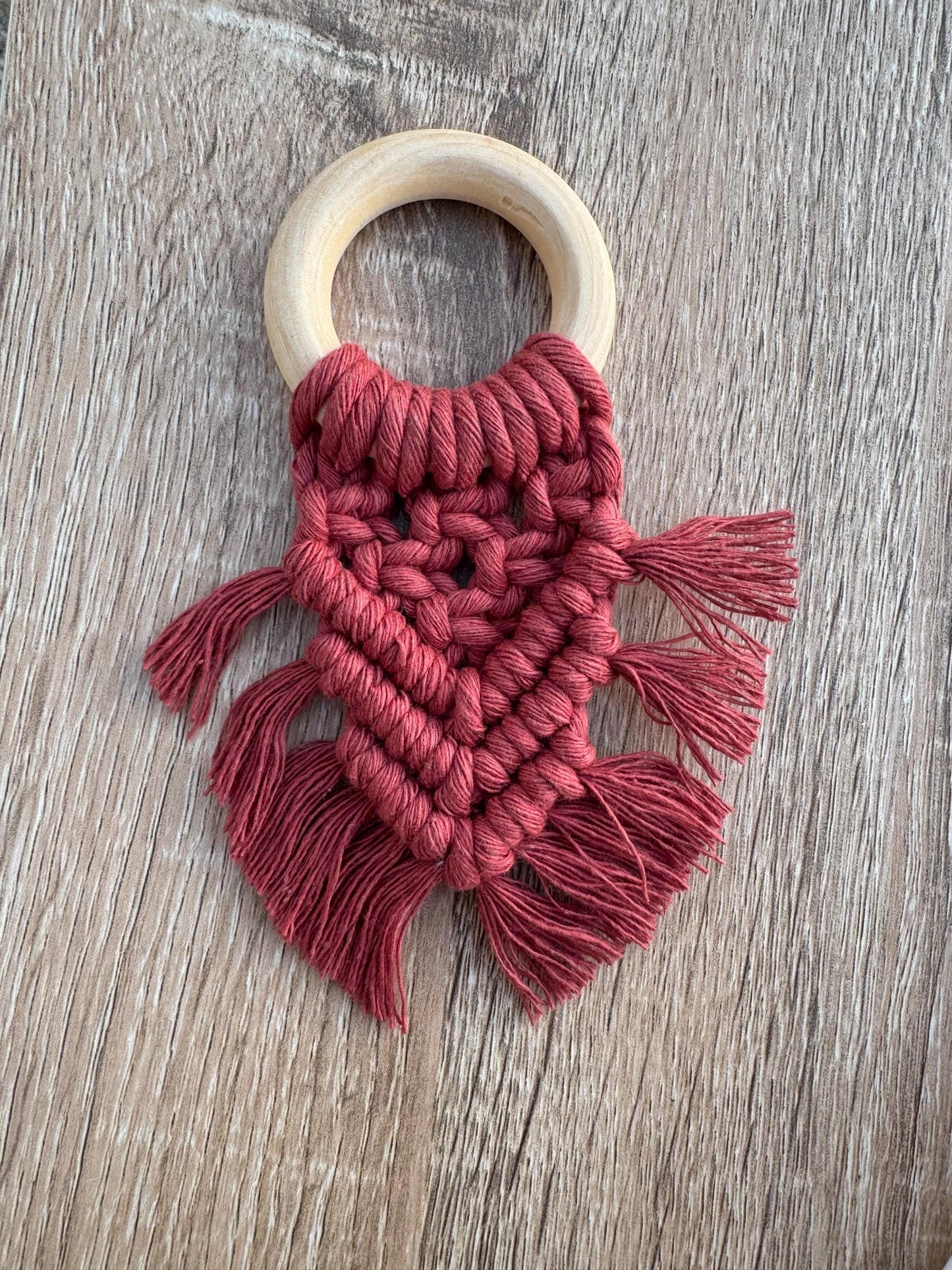 Macrame wooden napkin ring on a wooden surface