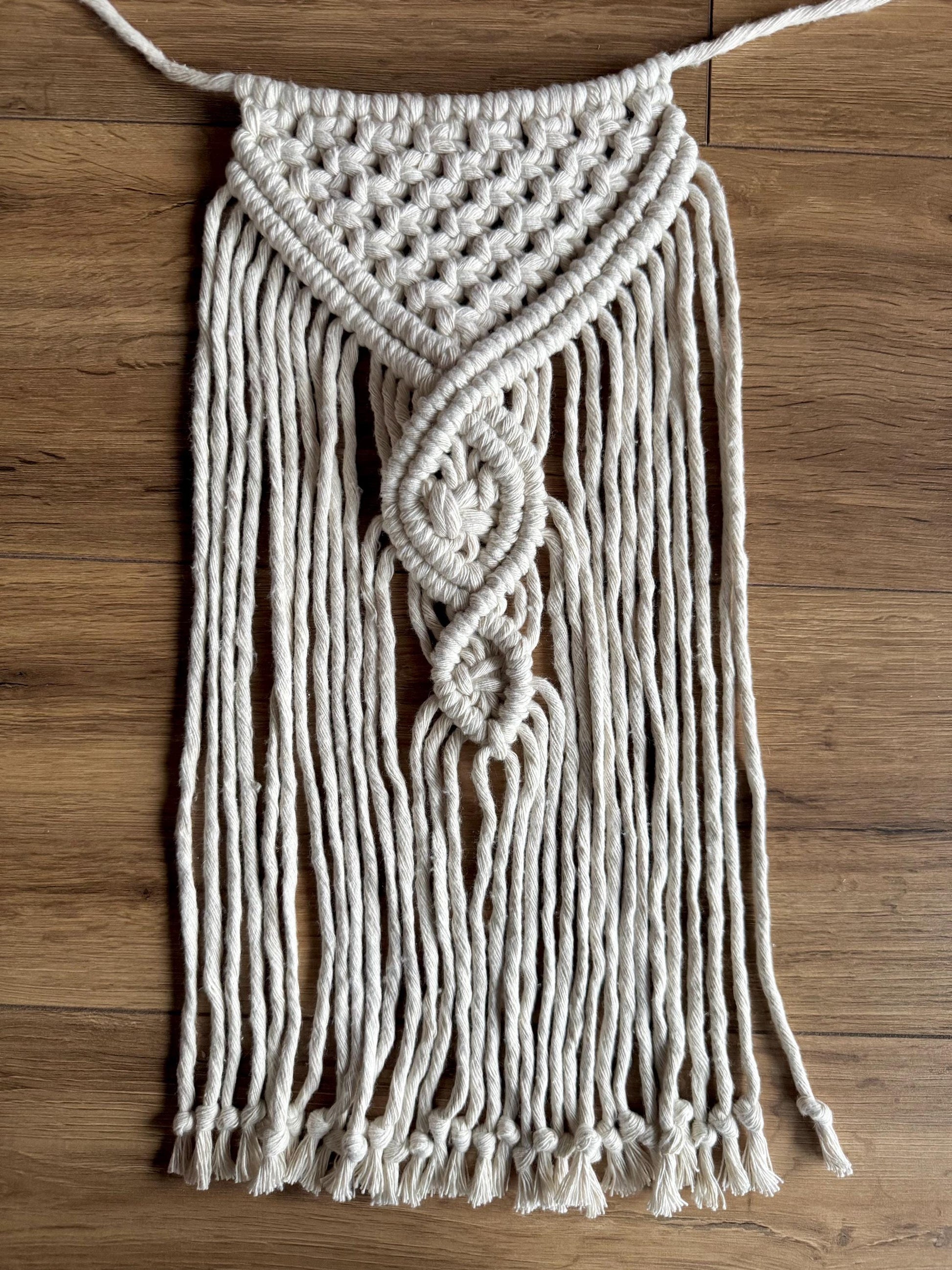 Macrame wall hanging on a wooden surface