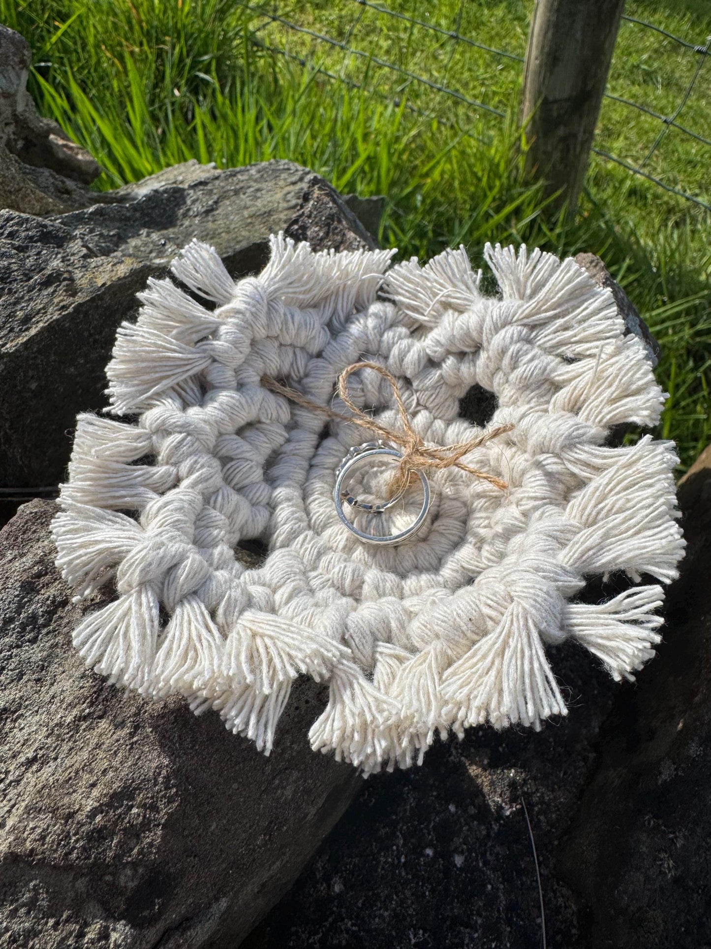 white macrame wedding ring holder with natural twine